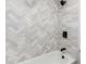 This bathroom features a shower and tub with white herringbone tile and black fixtures at 1591 S Sycamore Pl, Chandler, AZ 85286