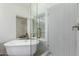 Elegant bathroom features a glass-enclosed shower, a soaking tub, and refined fixtures, offering a spa-like experience at 1591 S Sycamore Pl, Chandler, AZ 85286