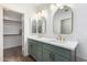 Bright bathroom featuring double sinks, modern fixtures, and a walk-in closet at 1591 S Sycamore Pl, Chandler, AZ 85286