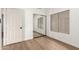 This bedroom features wood-style vinyl flooring, a mirrored closet and window with roller shades at 1591 S Sycamore Pl, Chandler, AZ 85286