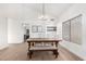 Bright dining room featuring a wooden table, bench seating, modern lighting, and built-in shelving with decor at 1591 S Sycamore Pl, Chandler, AZ 85286