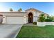 Charming home featuring a two-car garage, well-manicured lawn, and desert landscaping at 1591 S Sycamore Pl, Chandler, AZ 85286
