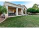 Exterior rear view of covered patio, manicured lawn, and walkway to home at 1591 S Sycamore Pl, Chandler, AZ 85286
