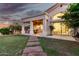 Backyard view of covered patio with outdoor seating and manicured lawn with walkway to the covered porch at 1591 S Sycamore Pl, Chandler, AZ 85286