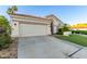 Charming home featuring a two-car garage, well-manicured lawn, and desert landscaping at 1591 S Sycamore Pl, Chandler, AZ 85286