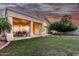 Spacious backyard features a covered patio, manicured lawn and a walkway to the main house at 1591 S Sycamore Pl, Chandler, AZ 85286