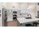 Well-equipped kitchen features white cabinets, stainless steel appliances, a marble backsplash, and a kitchen island at 1591 S Sycamore Pl, Chandler, AZ 85286