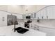 Modern kitchen boasts white cabinets, stainless steel appliances, a marble backsplash, and a kitchen island at 1591 S Sycamore Pl, Chandler, AZ 85286