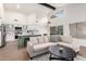 Open-concept living area with modern kitchen and a cozy seating arrangement under high ceilings at 1591 S Sycamore Pl, Chandler, AZ 85286