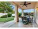 Outdoor seating on covered patio overlooks the green backyard. The ceiling fan provides a cool breeze at 1591 S Sycamore Pl, Chandler, AZ 85286
