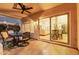 Covered patio features a ceiling fan, outdoor seating, and a view of the living room and kitchen at 1591 S Sycamore Pl, Chandler, AZ 85286