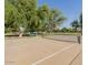 Pickleball court with nets and court lines, surrounded by mature trees and green space at 1591 S Sycamore Pl, Chandler, AZ 85286