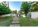 Landscaped backyard leads to private dock and pond at 1591 S Sycamore Pl, Chandler, AZ 85286