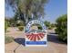 Pecos Park sign featuring an artistic mountain range surrounded by lush desert vegetation at 1591 S Sycamore Pl, Chandler, AZ 85286