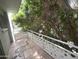 Balcony showcasing a distinctive tile design, unique railings, and views of surrounding trees at 1702 W Tuckey Ln # 209, Phoenix, AZ 85015