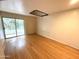 Bedroom featuring light-colored walls, hardwood floors, and a sliding door to a balcony at 1702 W Tuckey Ln # 209, Phoenix, AZ 85015