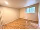 Bedroom featuring hardwood floors, a window view, and neutral walls at 1702 W Tuckey Ln # 209, Phoenix, AZ 85015
