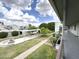 Relaxing courtyard view with manicured lawn, mature trees, and pathways from a home balcony at 1702 W Tuckey Ln # 209, Phoenix, AZ 85015