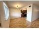 Open dining area next to kitchen with hardwood floors and stylish light fixture at 1702 W Tuckey Ln # 209, Phoenix, AZ 85015