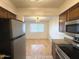 View from kitchen to dining area, showcasing open layout and hardwood flooring at 1702 W Tuckey Ln # 209, Phoenix, AZ 85015