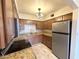 Renovated kitchen with stainless steel appliances, granite countertops, and wooden cabinetry at 1702 W Tuckey Ln # 209, Phoenix, AZ 85015