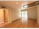 Open living room with light-colored walls, wood floor, and sliding doors to the balcony at 1702 W Tuckey Ln # 209, Phoenix, AZ 85015