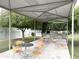 Community outdoor kitchen with grill, tables, chairs, and shaded canopy at 1702 W Tuckey Ln # 209, Phoenix, AZ 85015