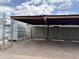 Covered parking area with assigned spaces and enclosed utility equipment at 1702 W Tuckey Ln # 209, Phoenix, AZ 85015