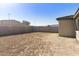 Spacious backyard featuring block wall fencing and potential for landscaping, creating a private outdoor oasis at 19033 W Rose Ln, Waddell, AZ 85355
