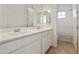 Bright bathroom features white cabinets, a double sink vanity, and a shower/tub combo at 19033 W Rose Ln, Waddell, AZ 85355