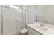 Bathroom featuring a glass-enclosed shower, toilet, and single sink at 19033 W Rose Ln, Waddell, AZ 85355