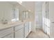 Bright bathroom features white cabinets, a double sink vanity, and a shower/tub combo at 19033 W Rose Ln, Waddell, AZ 85355