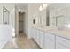 Bright bathroom featuring double sinks with quartz countertops and a separate shower at 19033 W Rose Ln, Waddell, AZ 85355