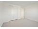 Bright bedroom features neutral carpet, white walls, and a double door closet at 19033 W Rose Ln, Waddell, AZ 85355