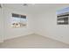 Bedroom with large windows and neutral carpeting at 19033 W Rose Ln, Waddell, AZ 85355