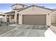 Attractive home with two car garage, concrete driveway, and minimalistic landscaping at 19033 W Rose Ln, Waddell, AZ 85355