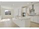 Spacious kitchen with a large center island, stainless appliances, and tile flooring at 19033 W Rose Ln, Waddell, AZ 85355