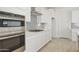 Modern kitchen with stainless steel appliances, gray backsplash, and quartz countertops at 19033 W Rose Ln, Waddell, AZ 85355