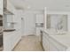 Bright, white kitchen featuring a gas cooktop, tile backsplash, and island with stainless steel appliances at 19033 W Rose Ln, Waddell, AZ 85355