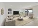Comfortable living area featuring a neutral color palette, stylish furniture, and a sliding glass door at 19033 W Rose Ln, Waddell, AZ 85355