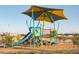 Modern community playground with blue slide and covered climbing structure with desert landscaping at 19033 W Rose Ln, Waddell, AZ 85355