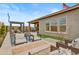 Beautifully landscaped backyard with a pool, fire pit, outdoor seating, and a modern pergola at 19420 W San Juan Ave, Litchfield Park, AZ 85340