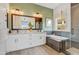 Luxurious bathroom with double vanities, a soaking tub, a large mirror, and a frameless glass shower at 19420 W San Juan Ave, Litchfield Park, AZ 85340