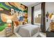 Themed bedroom with a camo wall, decorative letters, and a comfortable bed at 19420 W San Juan Ave, Litchfield Park, AZ 85340