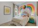 Colorful bedroom with playful wall decor, comfortable bed, and whimsical accents at 19420 W San Juan Ave, Litchfield Park, AZ 85340