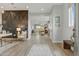 Bright entryway with wood-look tile flooring, modern decor, and an open floor plan that flows seamlessly into the dining area at 19420 W San Juan Ave, Litchfield Park, AZ 85340
