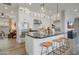 Bright kitchen features a large island, stainless steel appliances, and sleek white cabinets with bar stool seating at 19420 W San Juan Ave, Litchfield Park, AZ 85340