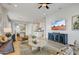 Bright living room featuring a ceiling fan, stylish furnishings and decor, and an open layout leading to the kitchen at 19420 W San Juan Ave, Litchfield Park, AZ 85340