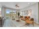 Inviting living room with a leather sofa, plush armchairs, modern decor, and seamless access to the outdoor pool area at 19420 W San Juan Ave, Litchfield Park, AZ 85340