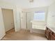 Bright bathroom showcasing a separate shower and soaking tub and wood style flooring at 19432 W Morning Glory Dr, Buckeye, AZ 85326